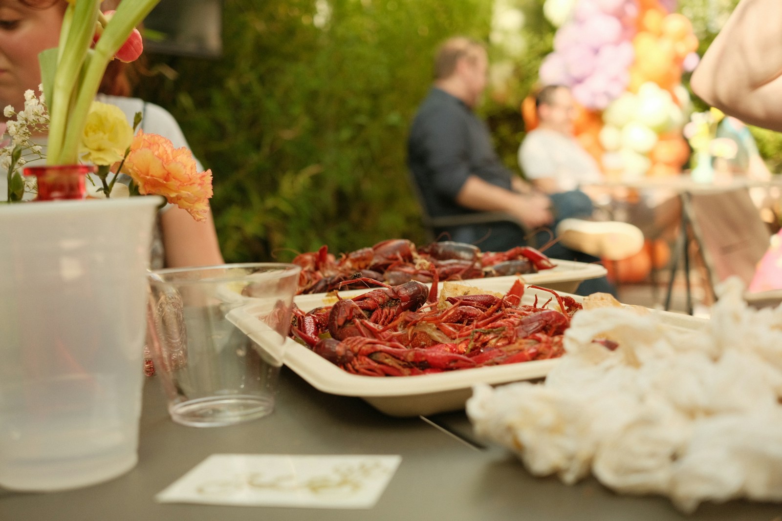 a couple of people sitting at a table with plates of food